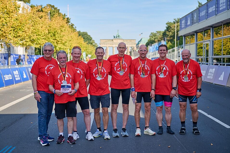 Skaters in red Jubilee T-shirts on the course in the finish area.