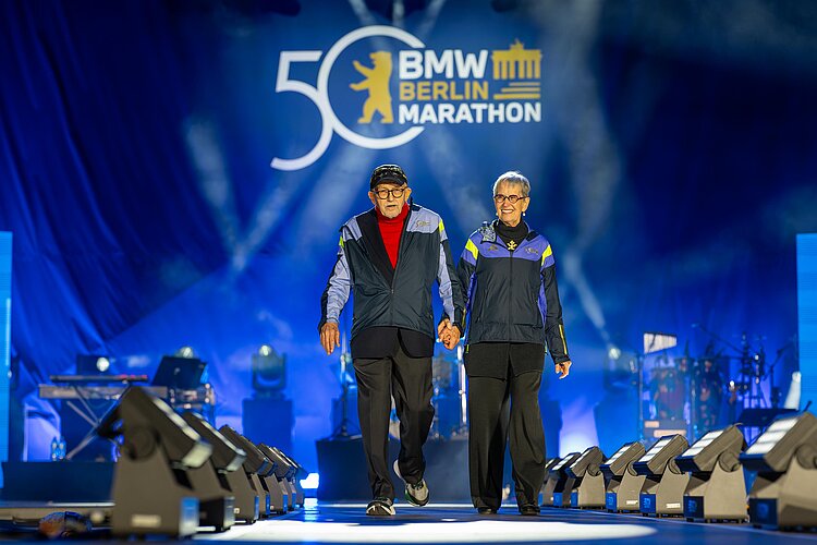 MW BERLIN-MARATHON: Sabine and Horst Milde on the stage in front of the Brandenburg Gate at the 50th anniversary celebration © SCC EVENTS